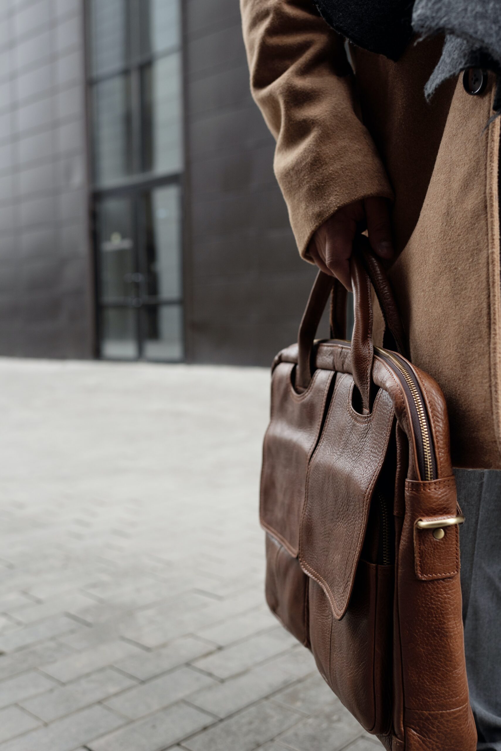 men holding leather laptop bag